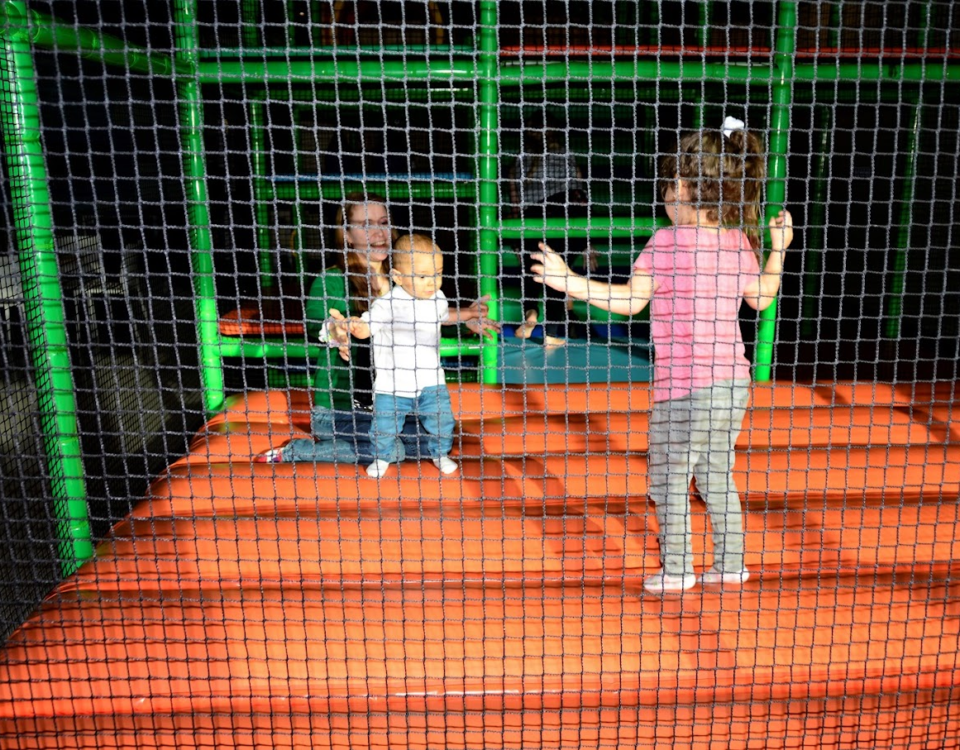 A mother with her kids inside a play area